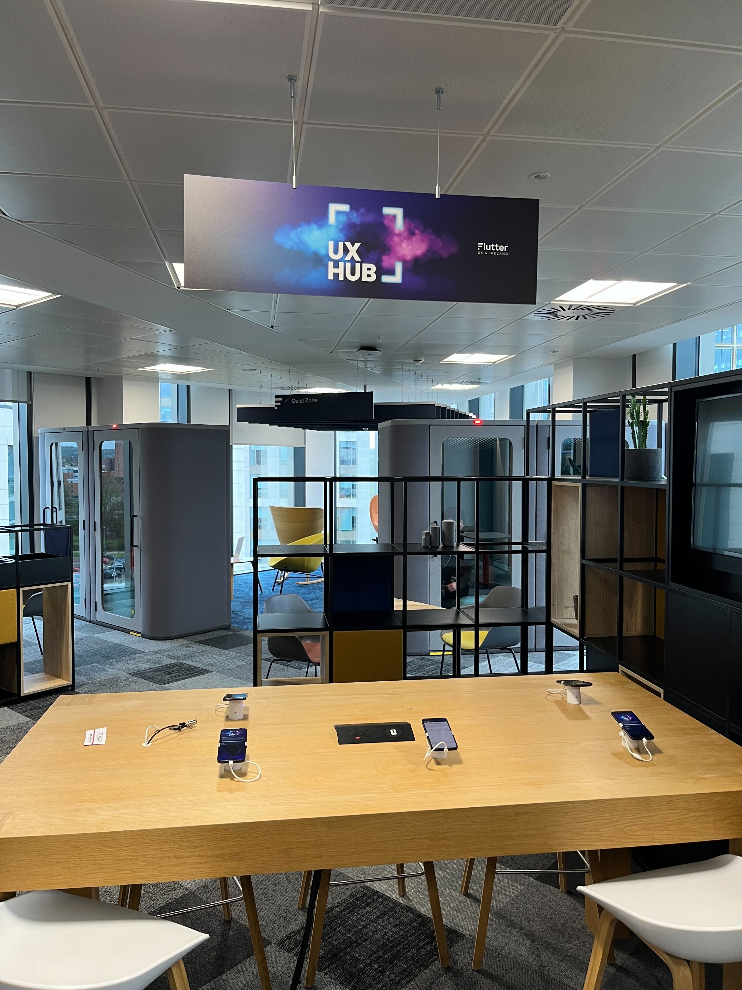 people standing around a table of mobile devices