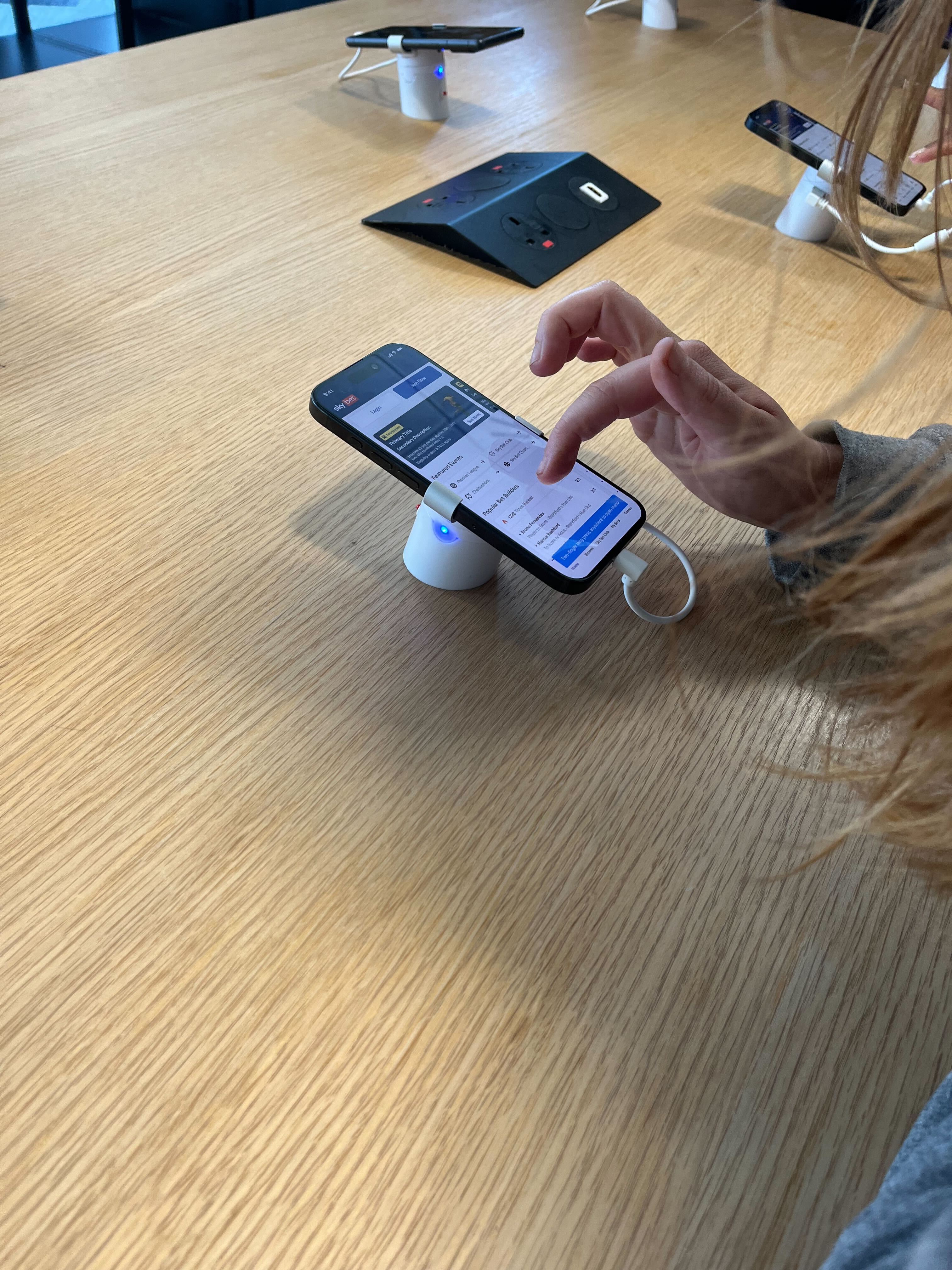 people standing around a table of mobile devices