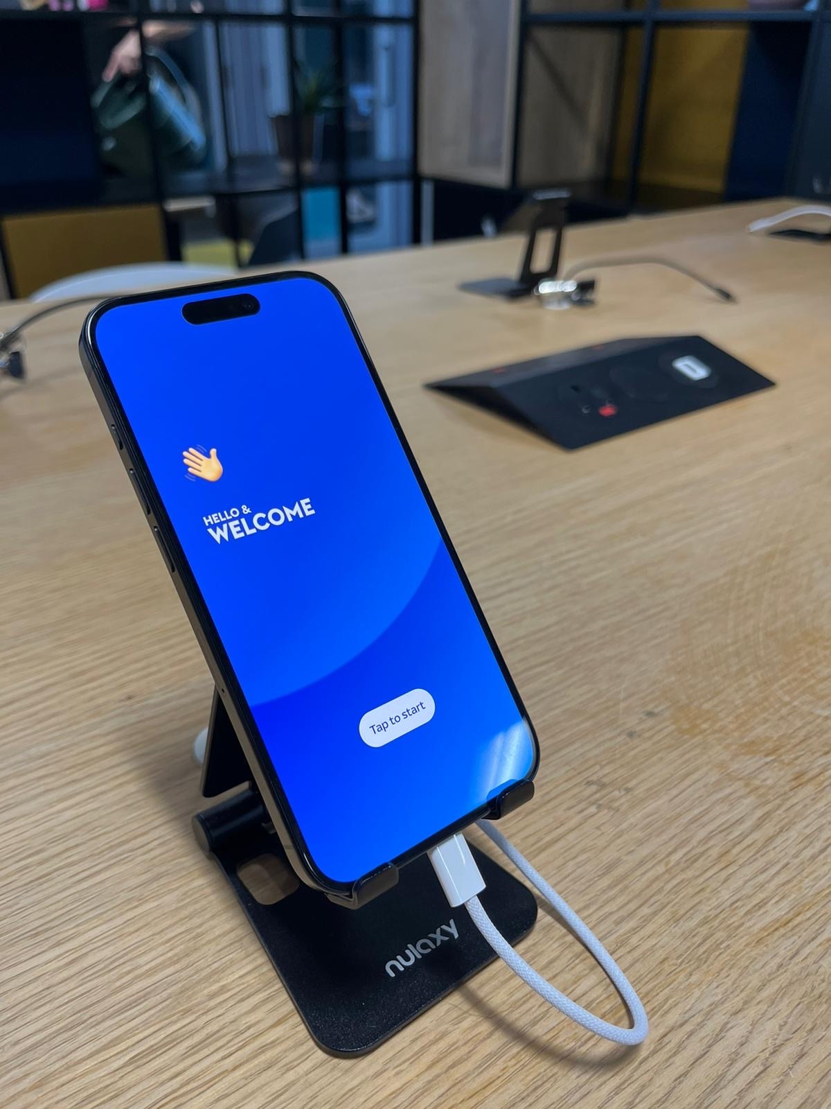 people standing around a table of mobile devices