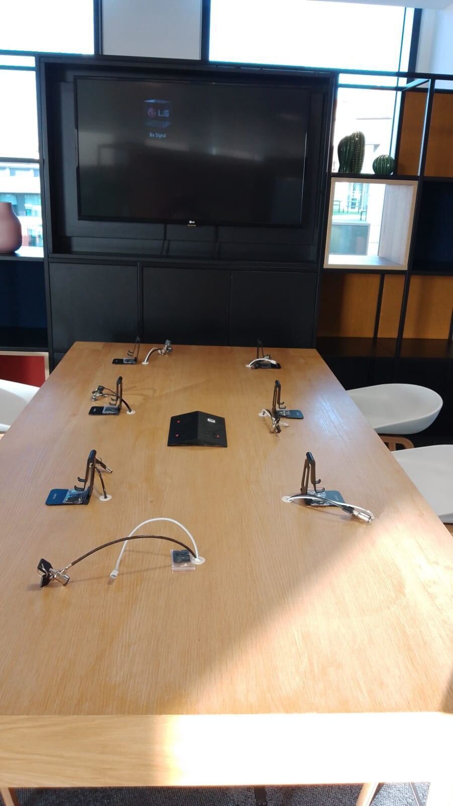 people standing around a table of mobile devices